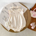 Apricot cotton double breasted sleeveless baby jumpsuit with matching hair band on white background
