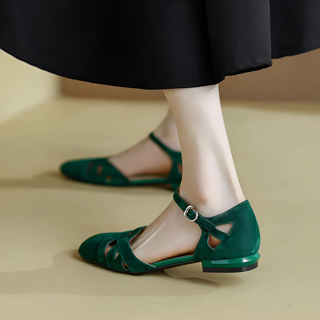 Apricot and green retro Roman sandals with a buckle strap and round toe on a rubber sole.