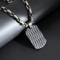 Men's titanium steel geometric water ripple pendant necklace on adjustable emperor chain in black, gold, or silver finish.