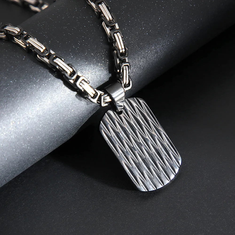 Men's titanium steel geometric water ripple pendant necklace on adjustable emperor chain in black, gold, or silver finish.