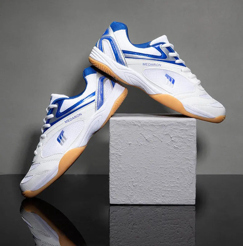 White and red table tennis sneakers with lace-up front and rubber sole.