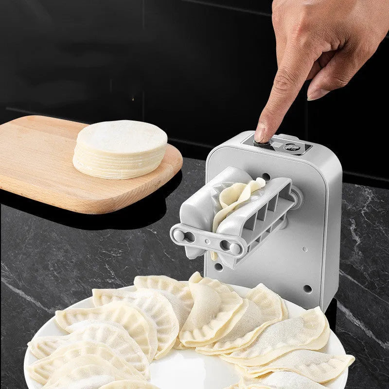 White electric dumpling maker machine with USB charging cable and accessories on kitchen counter
