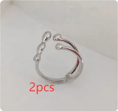 Adjustable brass ring with sphere design in gold or silver plating.