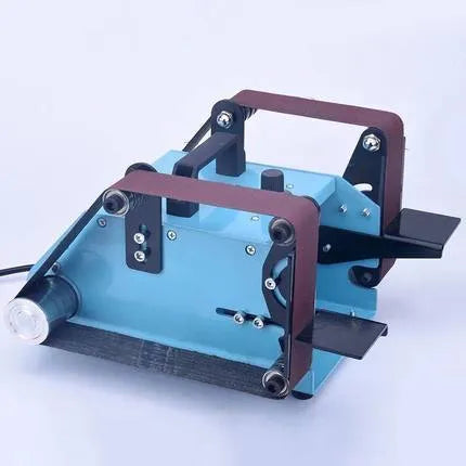 Blue desktop dual-axis belt sander with abrasive belt, variable speed switch, and compact chassis.