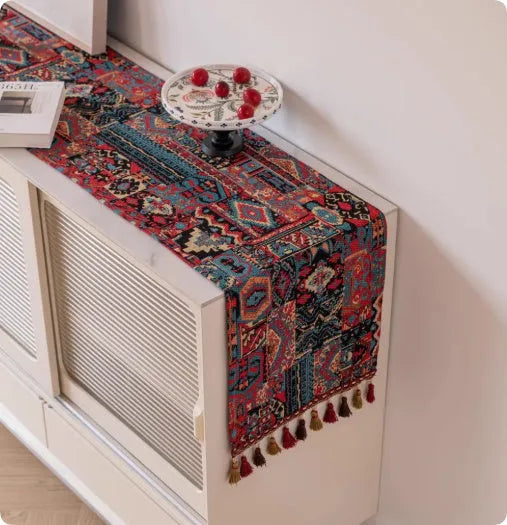 European retro style long table flag with handwoven tassels draped over a wooden sideboard
