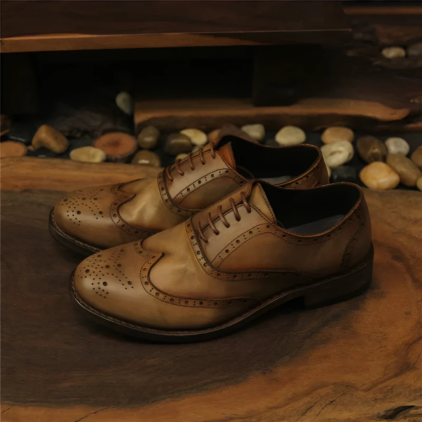 Men's light brown distressed leather lace-up shoes with engraved carving details on the upper.