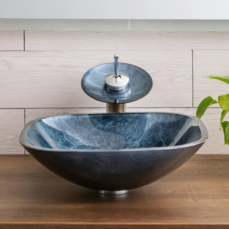 Blue grey tempered glass bathroom table basin with simple design on a vanity.