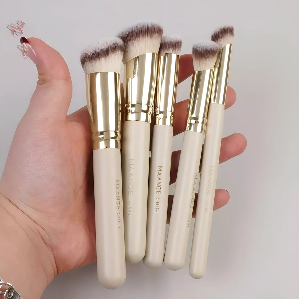 MAANGE apricot-coloured angled blush brush and four other makeup brushes on a table.