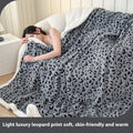 Double-layer cationic leopard jacquard taffeta blanket showing animal print pattern design