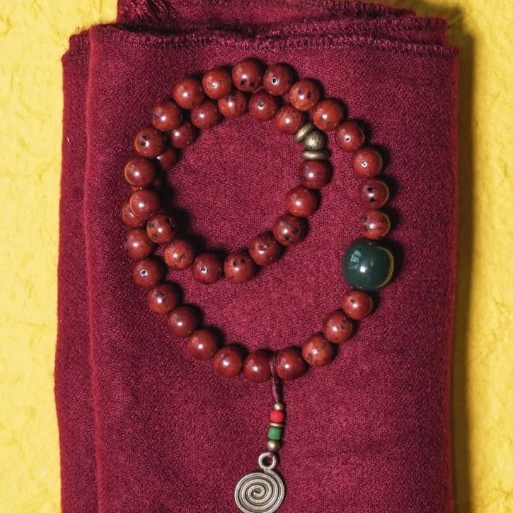 Close-up of a handmade double circle bracelet crafted from brown bodhi seeds on a wrist.