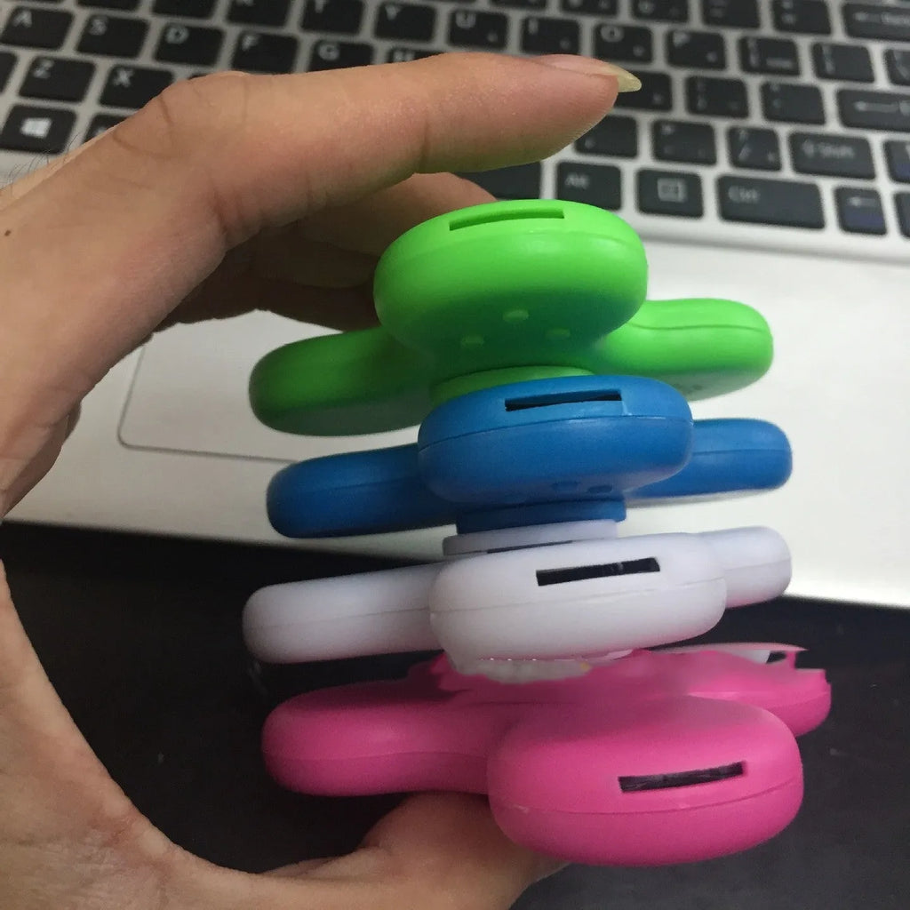 Square white Bluetooth speaker and fidget spinner toy with control buttons, measuring 80mm.