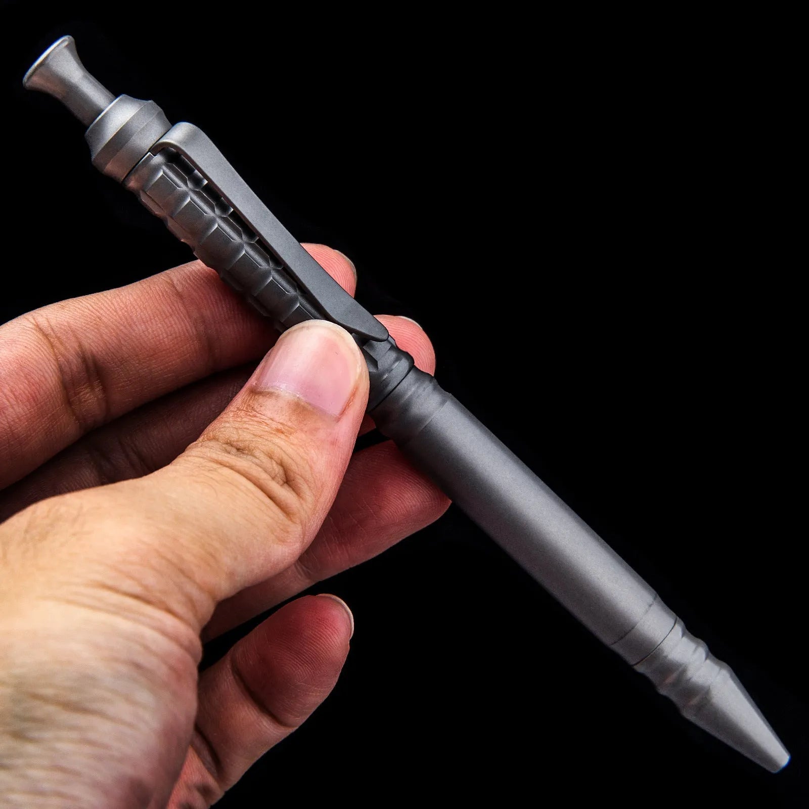 Gunmetal grey titanium alloy tactical pen with push-action button, shown in its gift box.