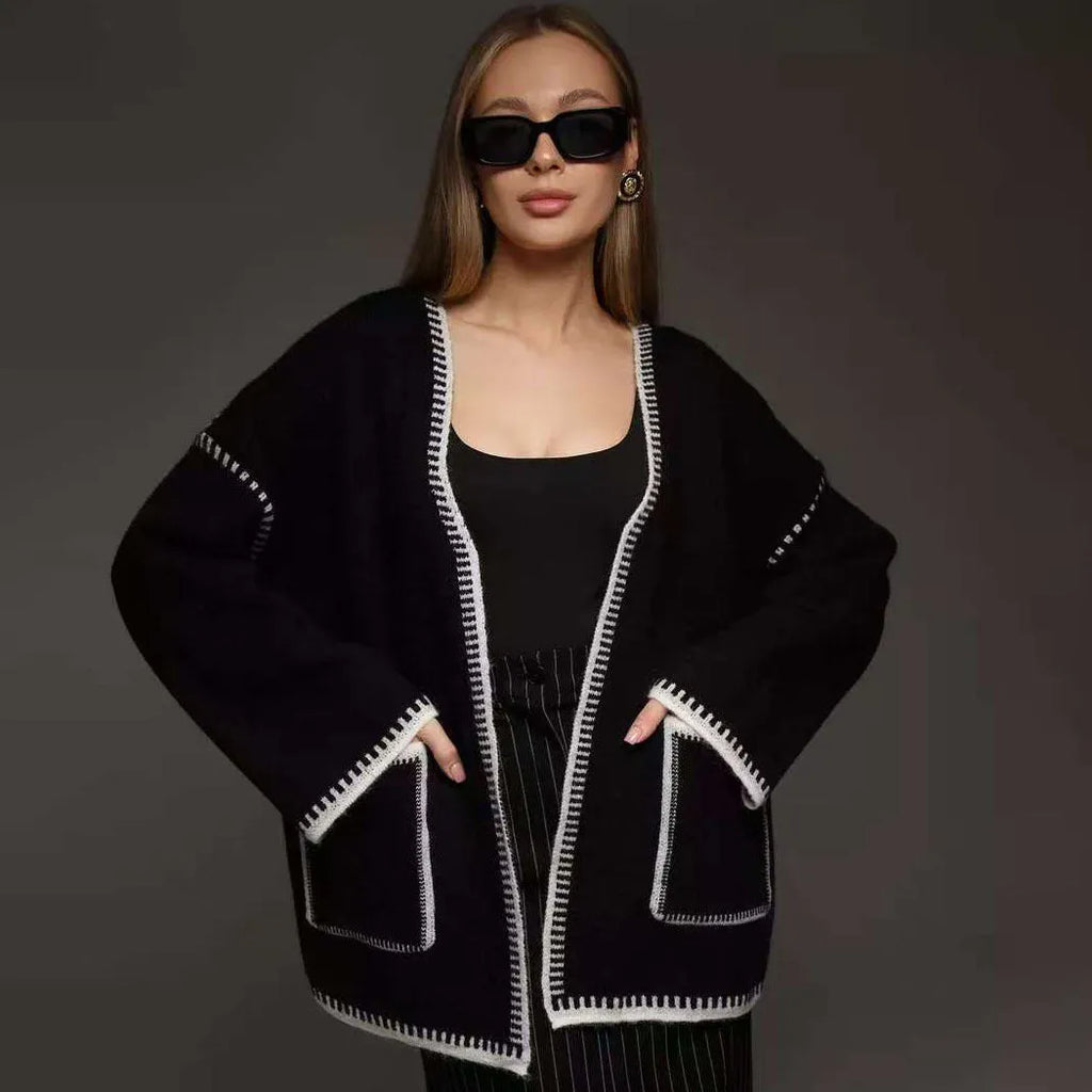 Loose mid-length knitted cardigan in camel colour on a hanger