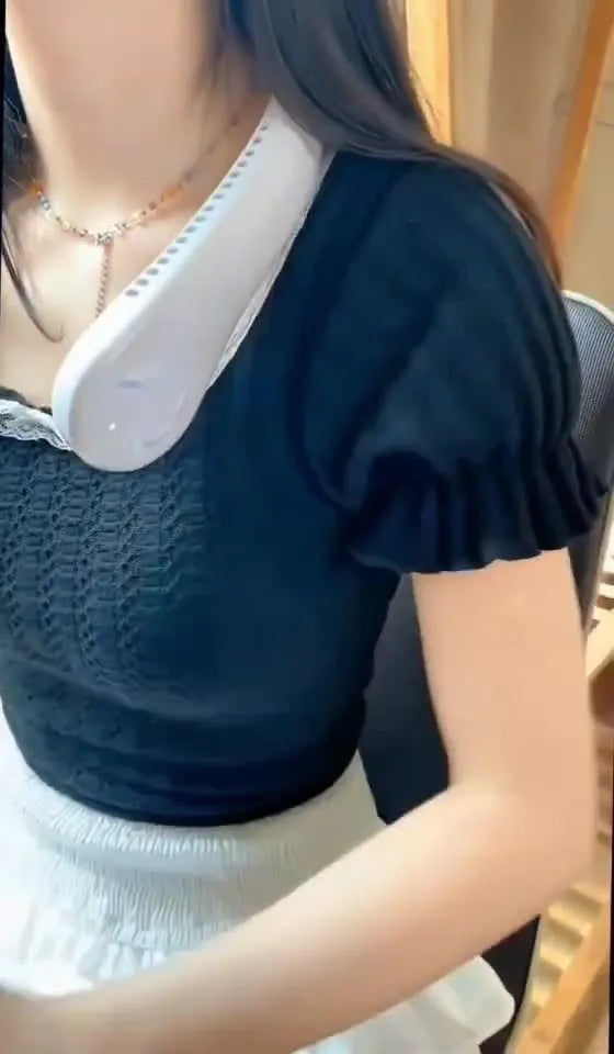 Blue bladeless neck fan hanging around a person's neck, showing the USB charging port and control buttons.