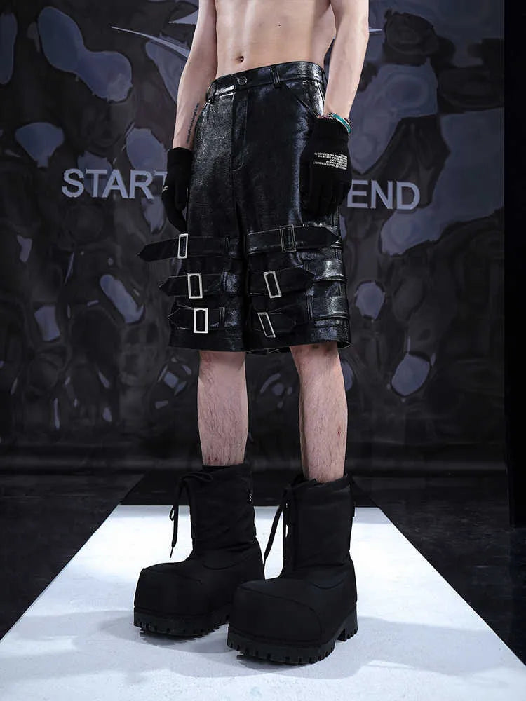 Black men's PU leather casual shorts with ring detailing, shown in a cropped pants style.