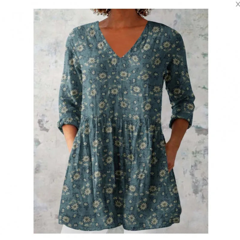 Women's loose-fit dress with blue and white wave pattern print and three-quarter length sleeves.