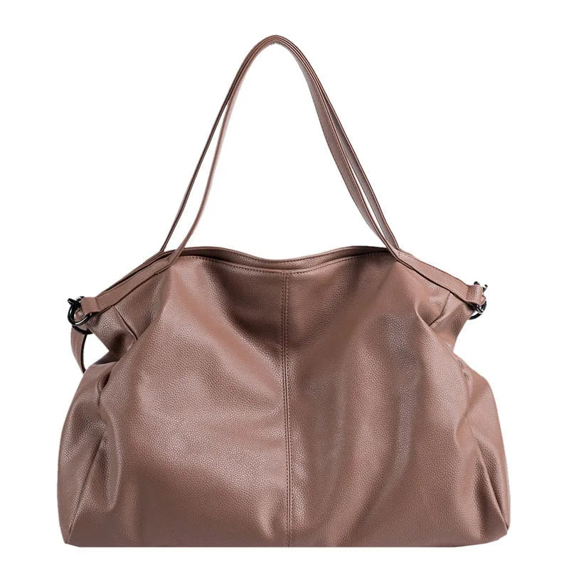 Soft surface PU leather messenger tote bag in a horizontal square shape with an adjustable shoulder strap.