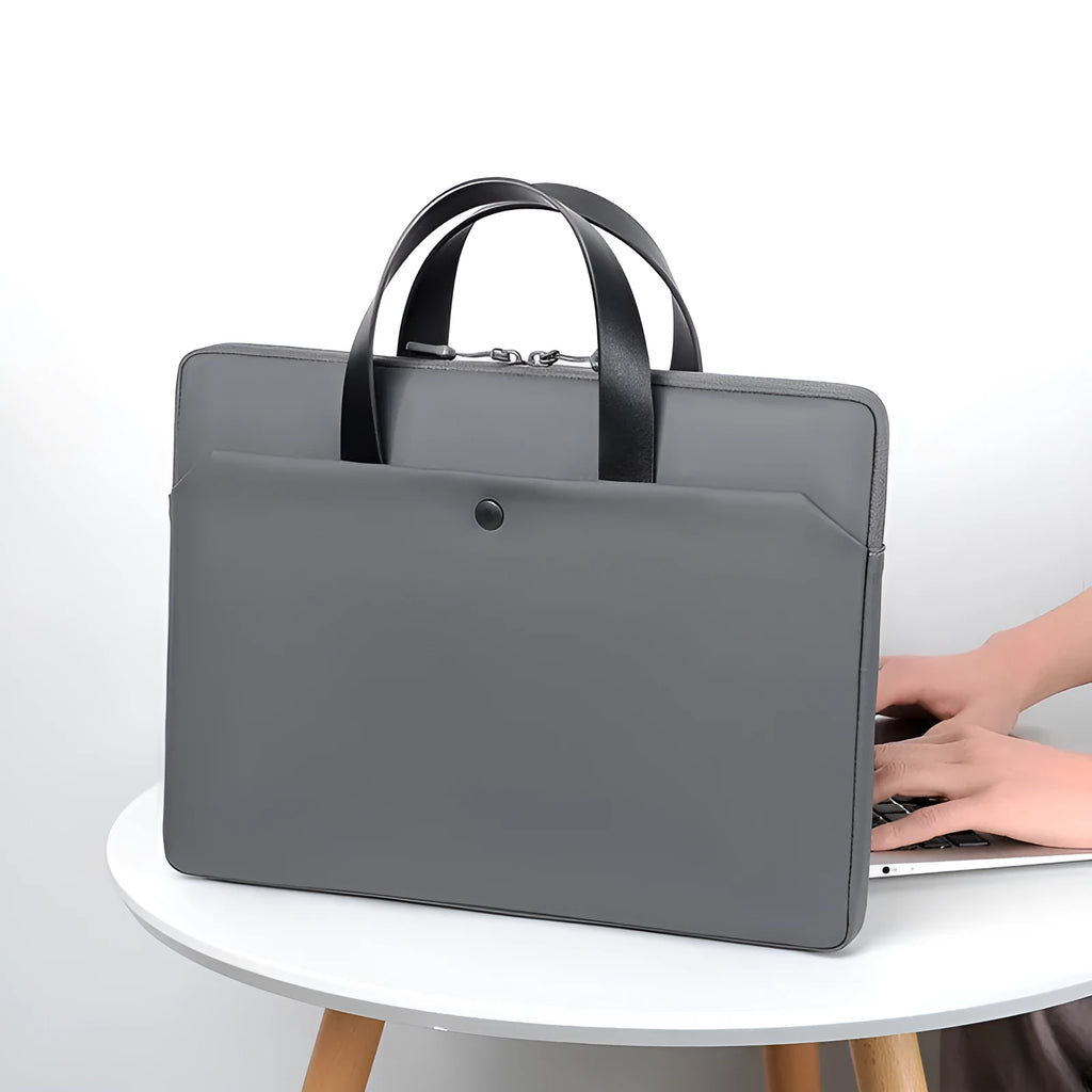 Ultra-thin leather laptop case in light grey with zipper closure and soft handle for 14 inch devices