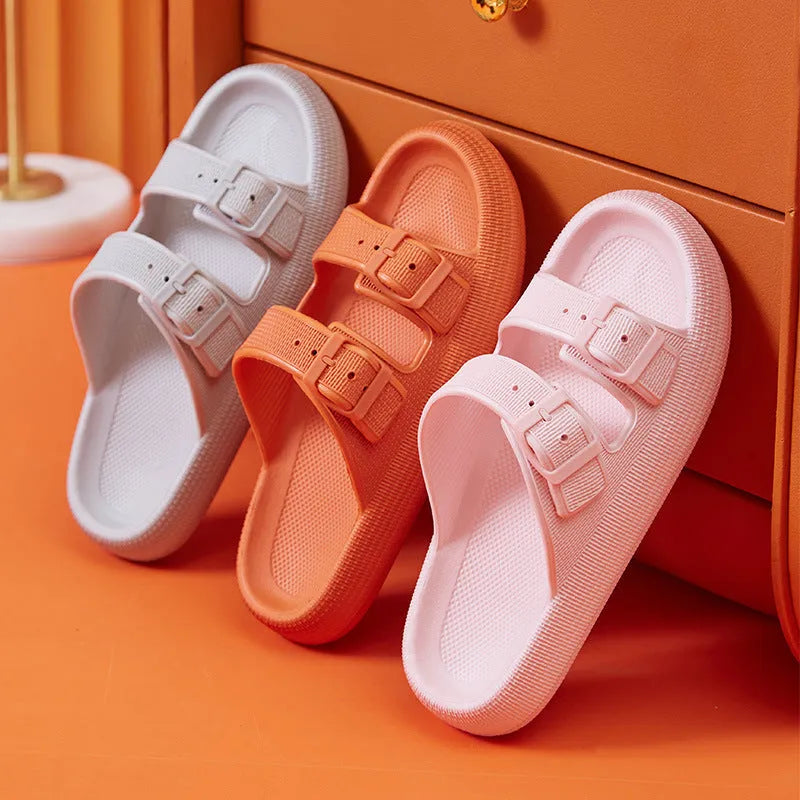 Women's beige platform slippers with buckle fastening and round toe on a flat surface