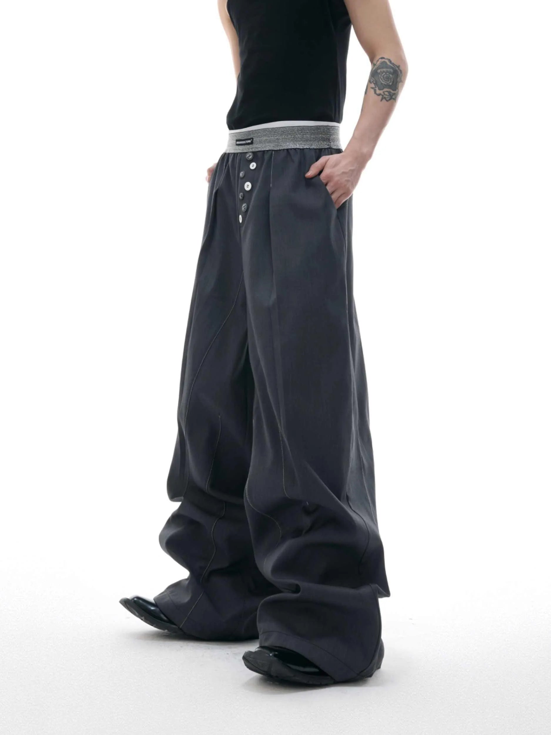 A pair of high-waisted straight-leg casual trousers in a black polyester-cotton blend with a button fly and open hem.