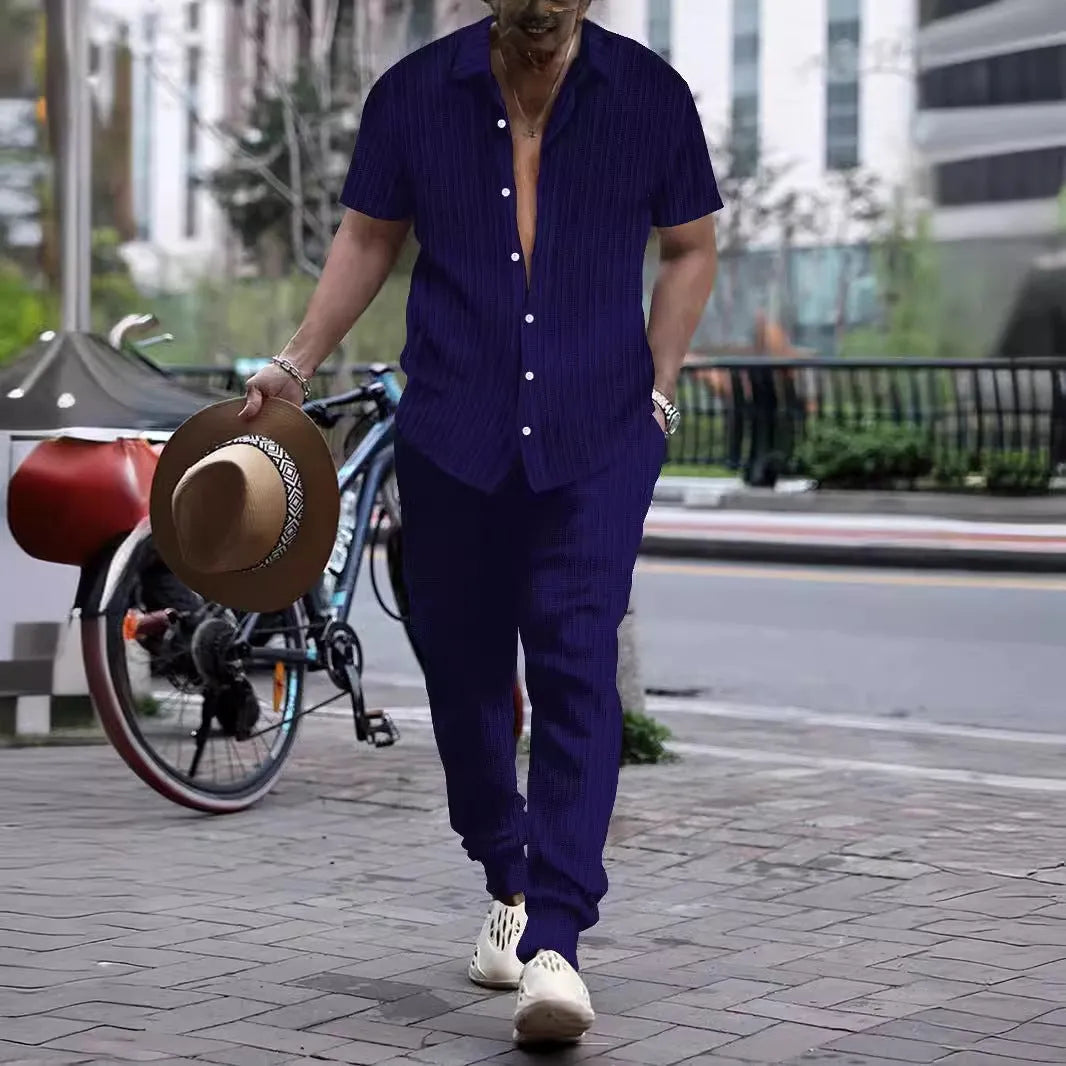 Men's loose fit casual beach suit set in cotton blend fabric, showing short sleeve shirt and trousers.