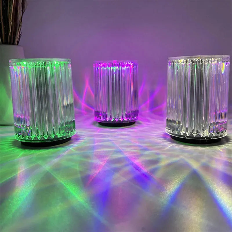 Compact acrylic crystal LED table lamp with RGB colours and remote control on a desk
