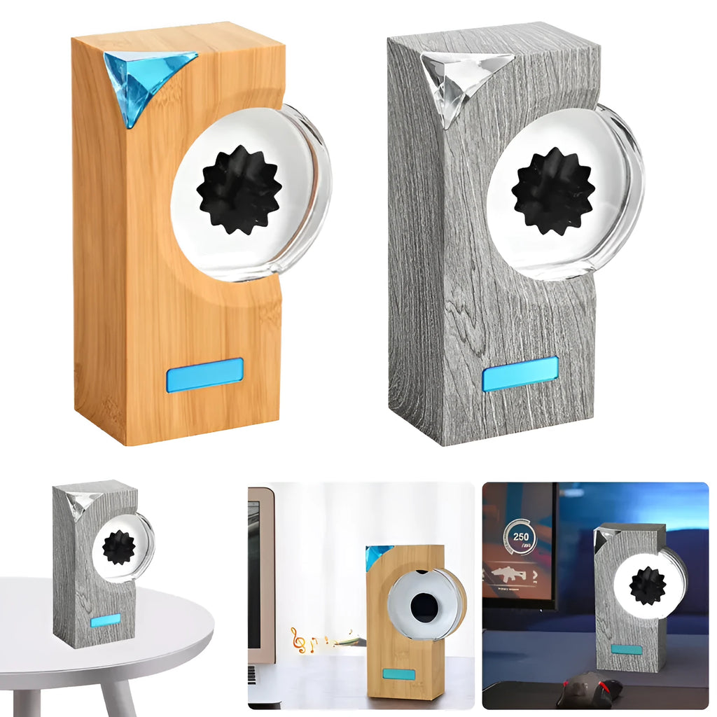 Dancing ferrofluid speaker in gray plastic casing with warm white light showing magnetic fluid shapes