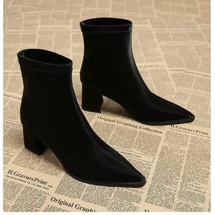 Women's khaki pointed toe Martin boots with a wedge heel on a rubber sole.