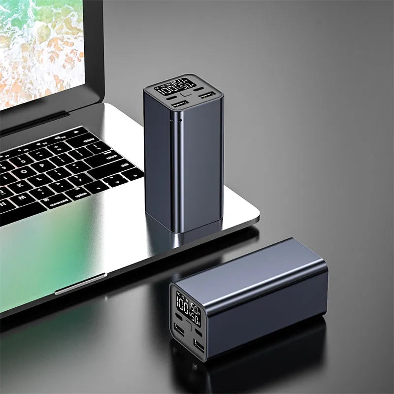 A black 65W high power laptop charging bank with a metal case, showing its dimensions.