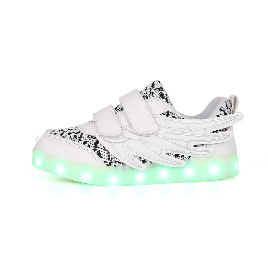 Children's plum red and white LED light-up sneakers showing USB charging port and colourful illumination.