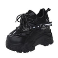 Women's white and black breathable mesh platform sports shoes with cross-strap and rubber sole.