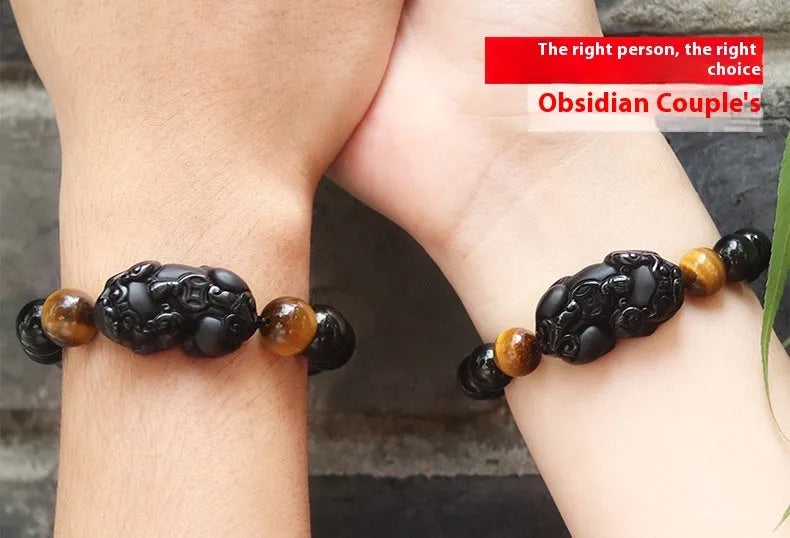 Mexico gold sheen obsidian Pi Xiu bracelet in unisex ethnic style on a wrist.