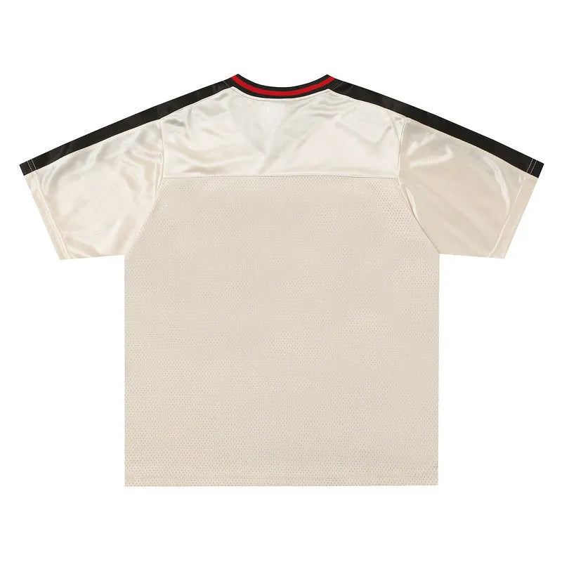 Apricot coloured loose sports top with V-neck design and drop-shoulder sleeves