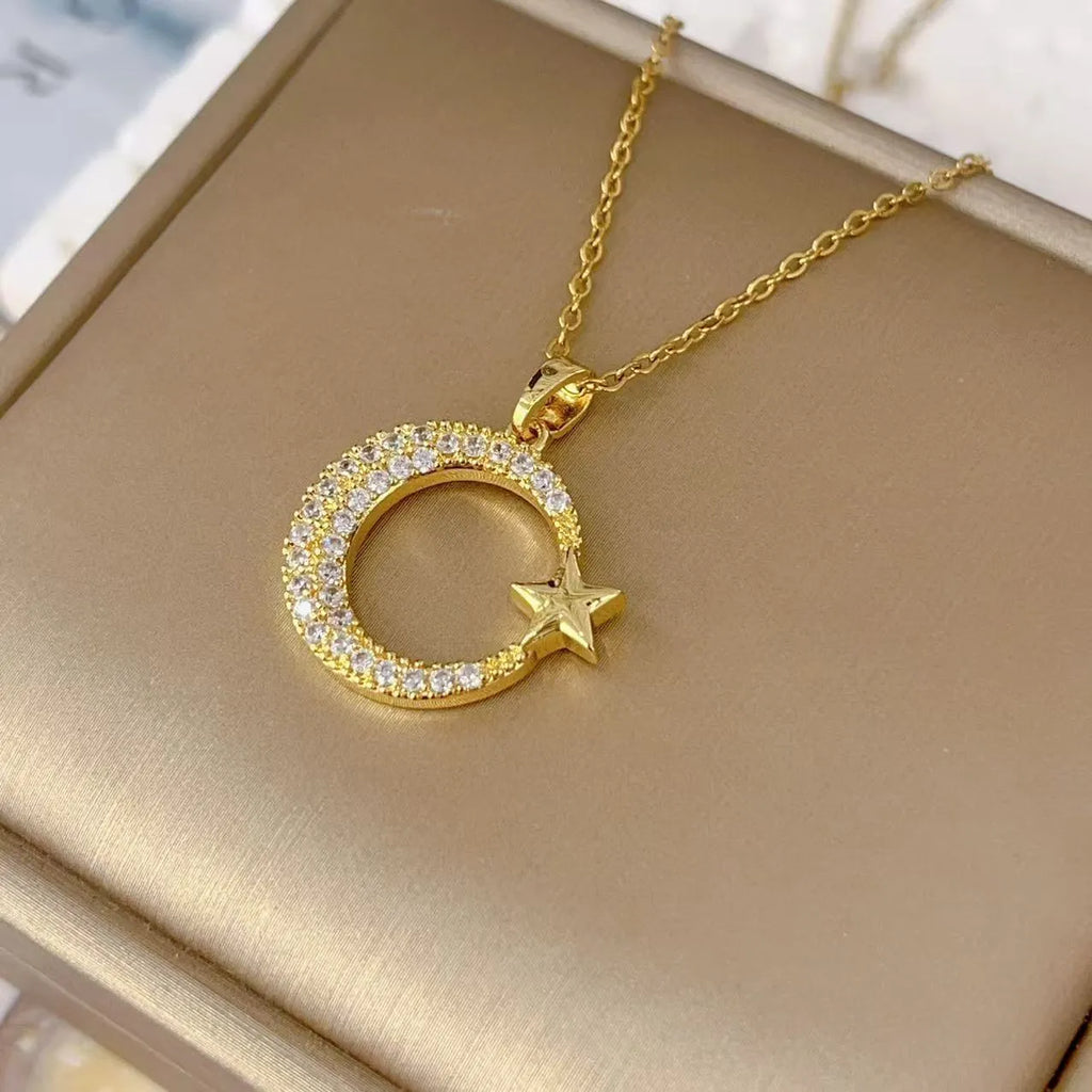 Xingyue gold geometric moon pendant necklace with zircon stone on titanium steel O-ring chain against white background