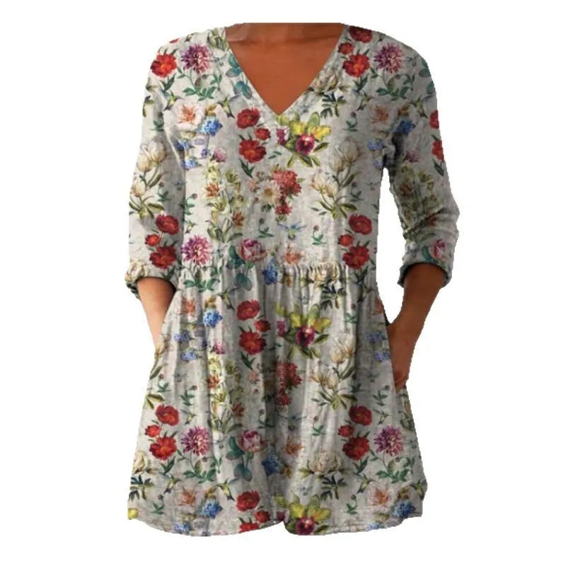 Women's loose-fit dress with blue and white wave pattern print and three-quarter length sleeves.