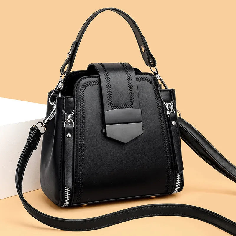 Small square vertical handbag in soft PU leather with textured stitching, shown in multiple colour options.