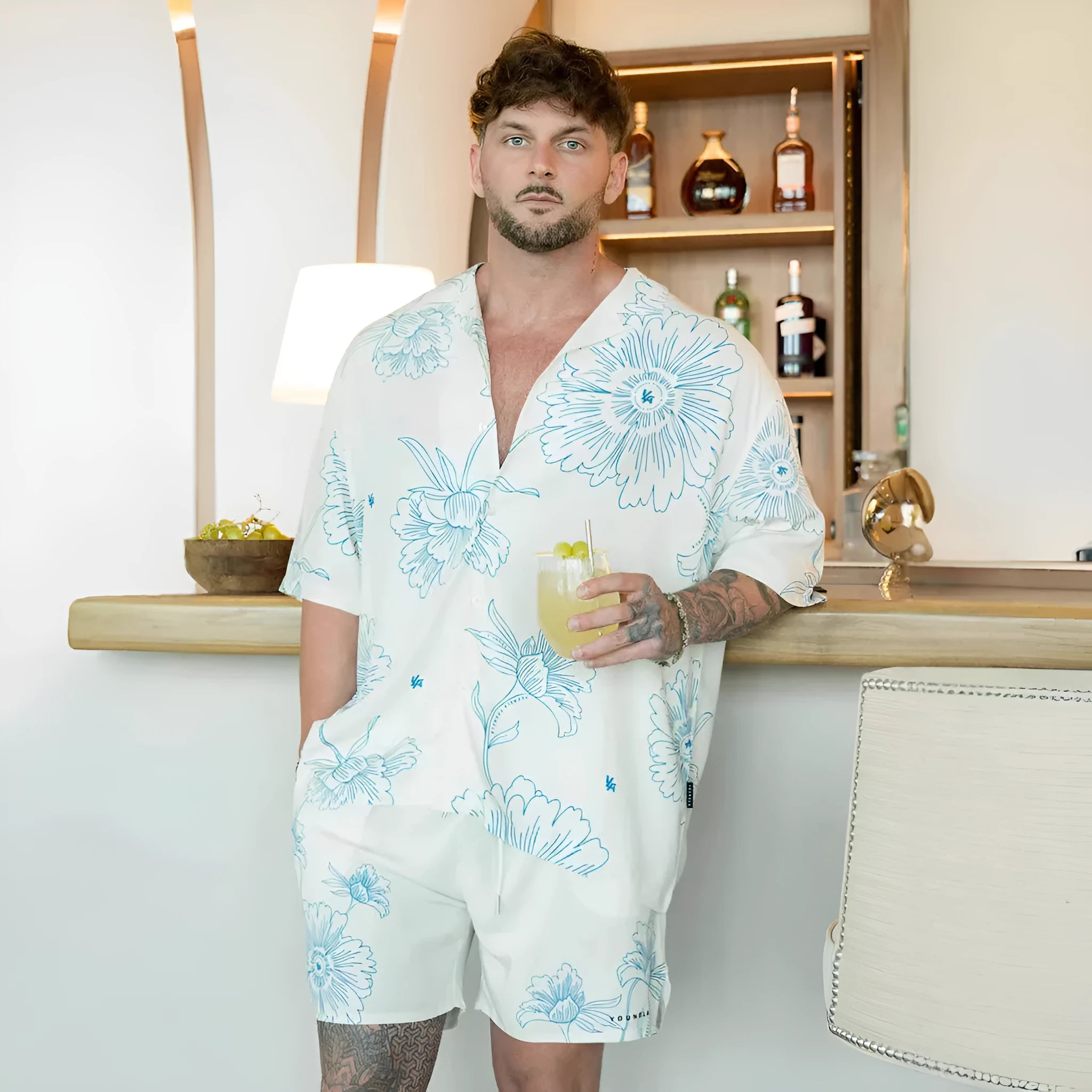 Man's loose-fitting short sleeve cardigan top with a floral print in light colours.