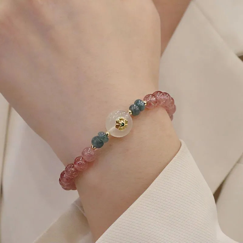Women's strawberry quartz bracelet with blue water emerald jade pendant, geometric shapes, and traditional Chinese symbolism