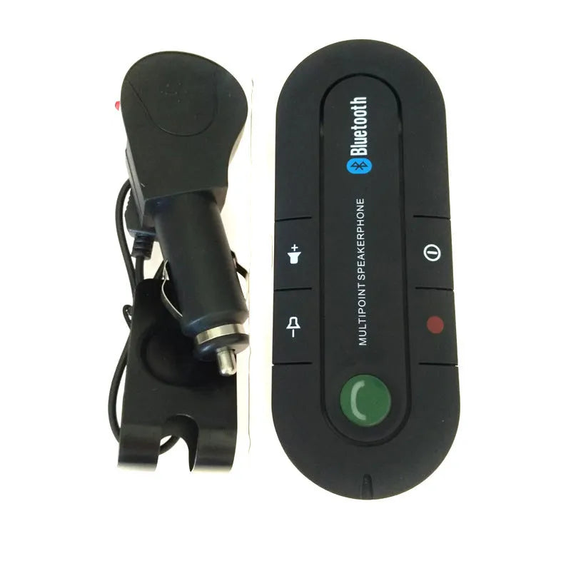 Black car Bluetooth handsfree kit clipped to a sun visor, showing the speaker grille and included car charger.