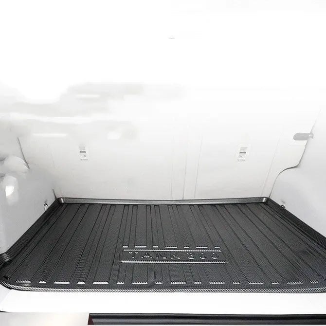 Black TPE car boot liner with carbon fibre pattern texture lying flat.