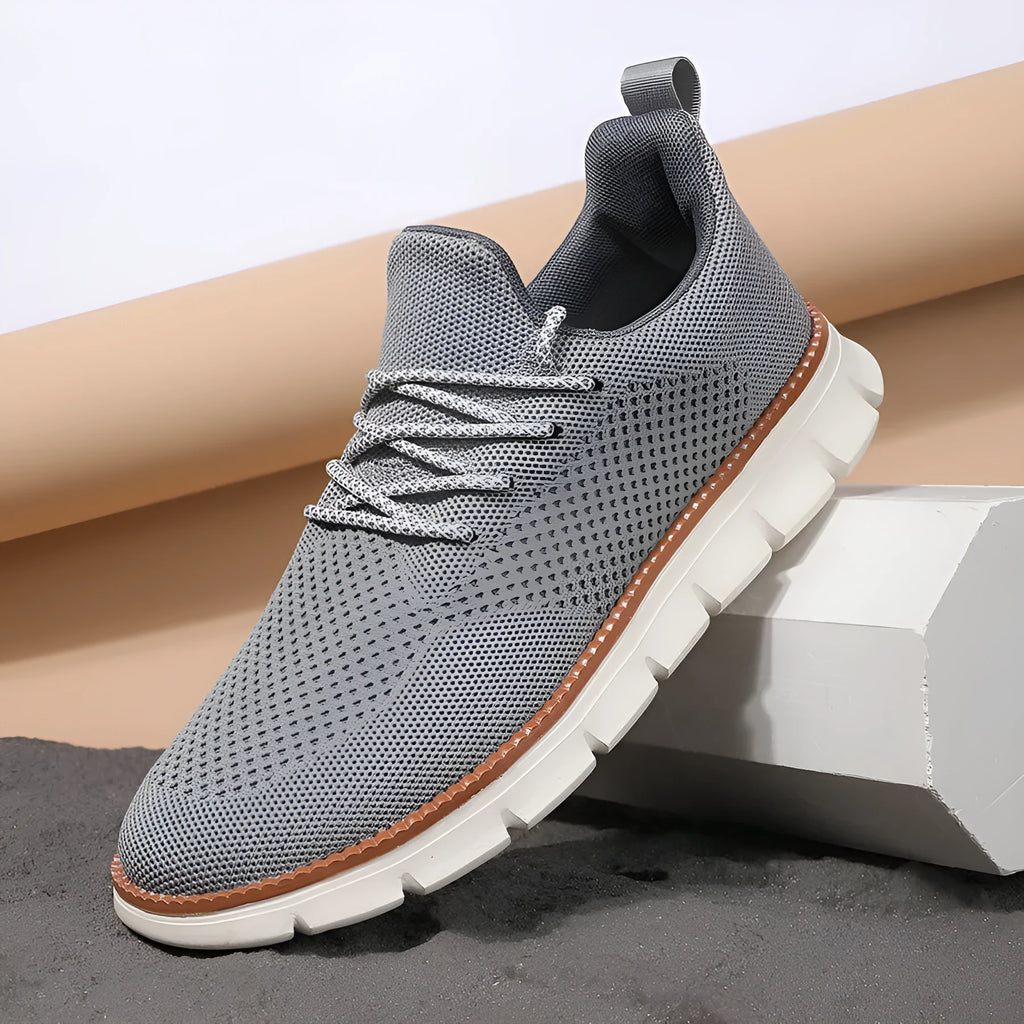 Men's grey and black low-heel casual sneakers with woven mesh fabric uppers and round toe.