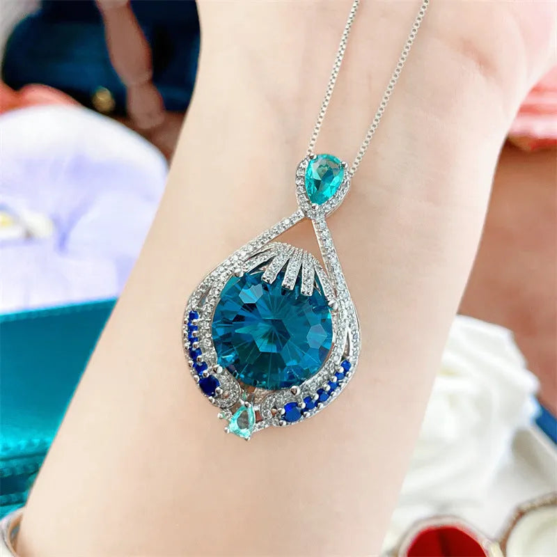 Blue geometric necklace with fireworks-cut crystal pendant on water wave chain
