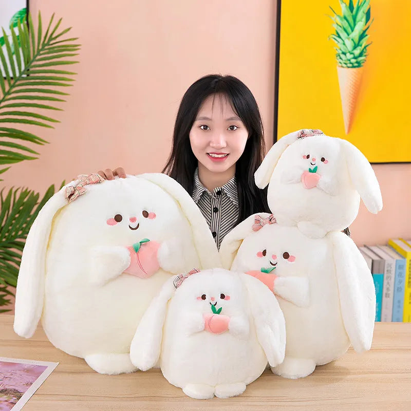 Rabbit peach plush toy in 20cm, 25cm, 35cm and 45cm heights on a plain background