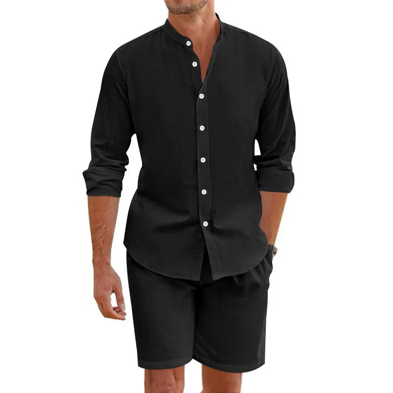 Men's dark grey linen blend summer suit with button-down short sleeve shirt and drawstring shorts.