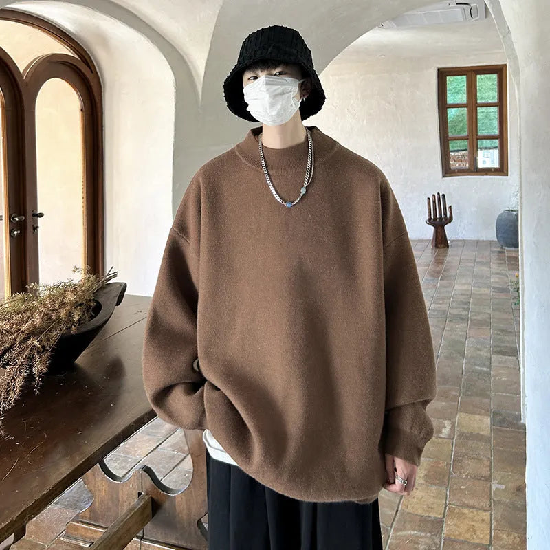 Men's loose fit round neck pullover sweater in a solid colour on a hanger.