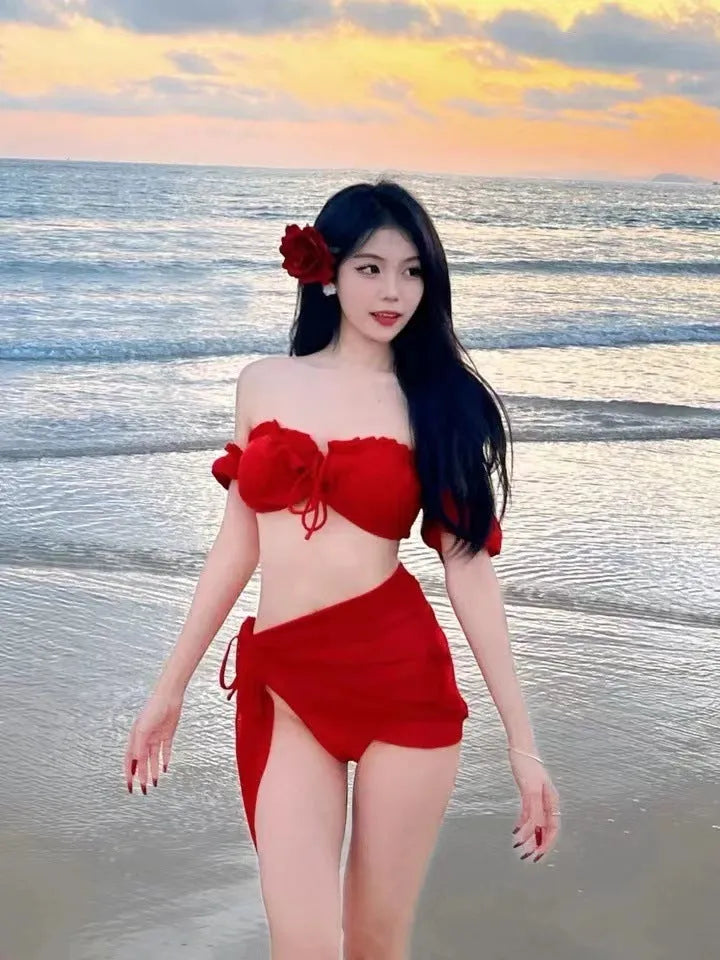 Red women's bikini swimsuit with puff sleeve top and solid briefs laid flat