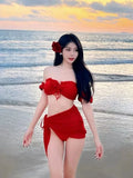 Red women's bikini swimsuit with puff sleeve top and solid briefs laid flat