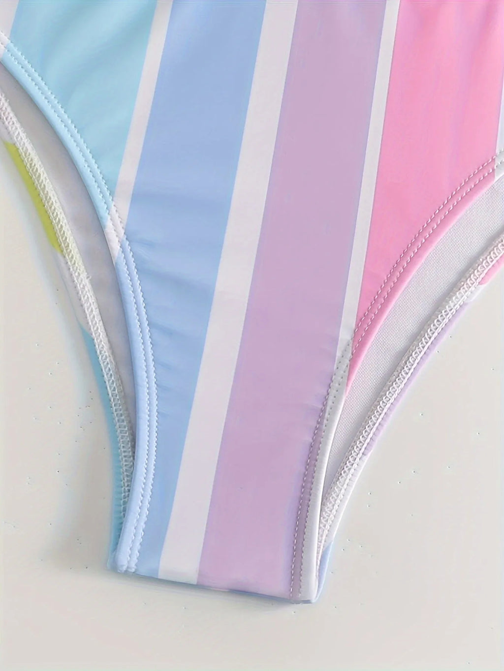 Women's striped sports bikini top and pants set on a mannequin.