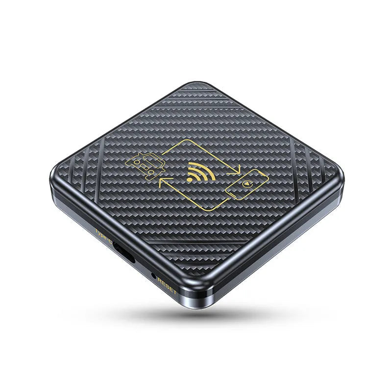 Gold and white wireless CarPlay and Android Auto USB adapter box for cars on a dark surface.