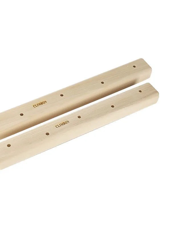Set of three solid wooden grip strength training hangboards in different sizes on a grey background.